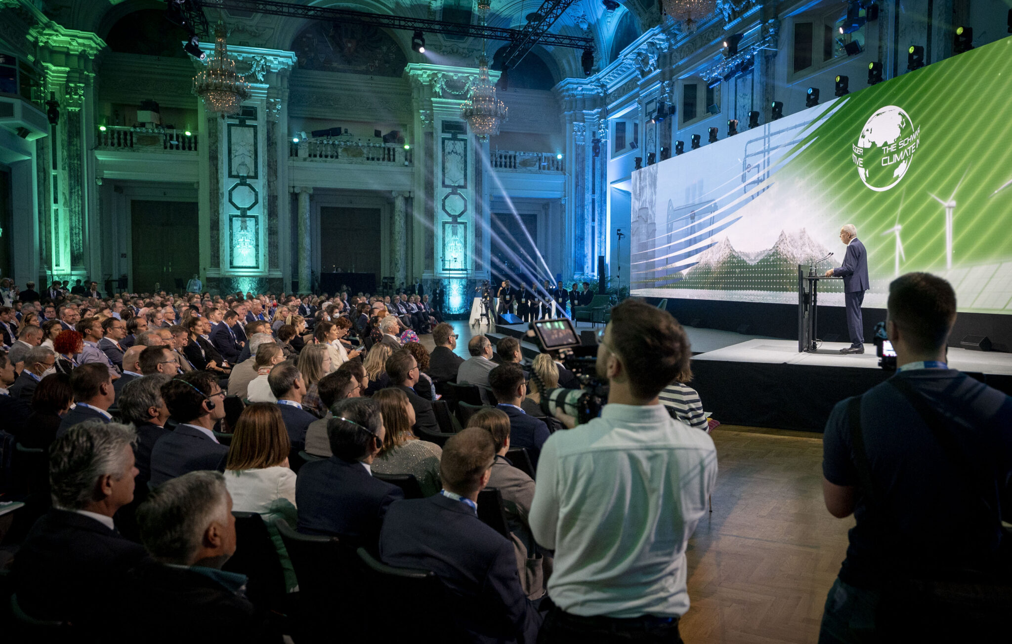 Speaker on a stage speaking to audience