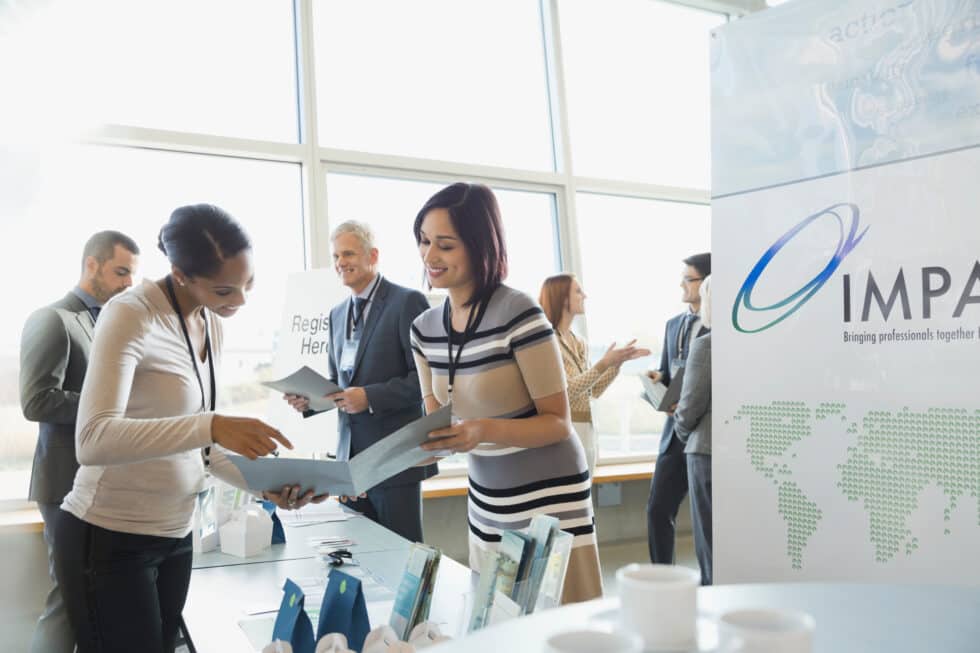 People talking at a booth, pratice of Field Marketing