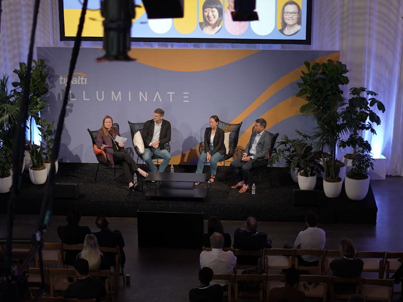 People hosting a summit session on a stage for their company